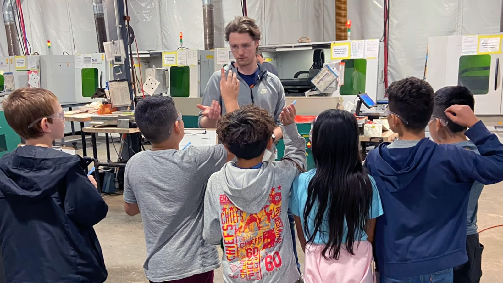 PREP-KC students watching a demonstration on the manufacturing floor