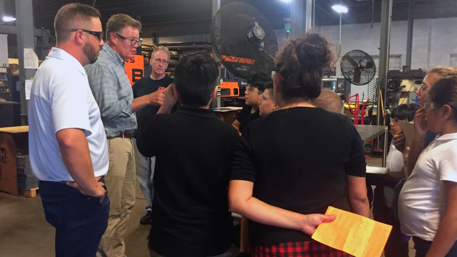 Northland CAPS interns talking with Holland 1916 staff on the floor